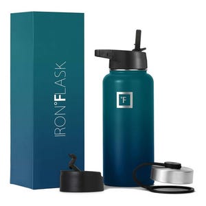 Iron Flask water bottle with two lids; one straw lid and one stainless steel lid, beside its packaging.