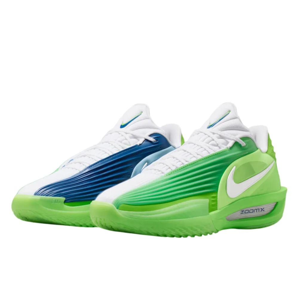 White Nike sneakers with asymmetric green and blue gradient panels, featuring a ZoomX sole.