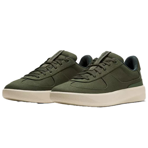 A pair of olive green casual sneakers with a low-top design and beige rubber soles.