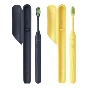 Two Philips One Electric Toothbrushes with travel cases, one in navy blue and the other in yellow, featuring sleek designs and on/off buttons.