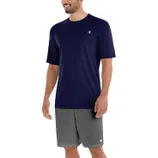 A man wearing a navy blue T-shirt and gray shorts, both featuring a small logo on the chest and pant leg.