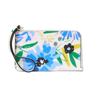 A Kate Spade wristlet featuring a vibrant floral print with blue, pink, green, and black flowers. It has a zip closure and a black wrist strap.