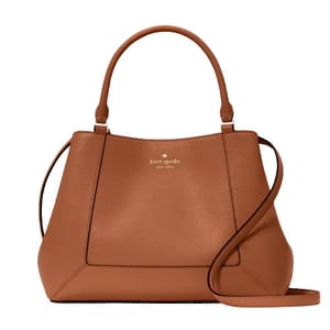 A brown Kate Spade leather satchel with a top handle and an adjustable, detachable crossbody strap, featuring the brand logo on the front.