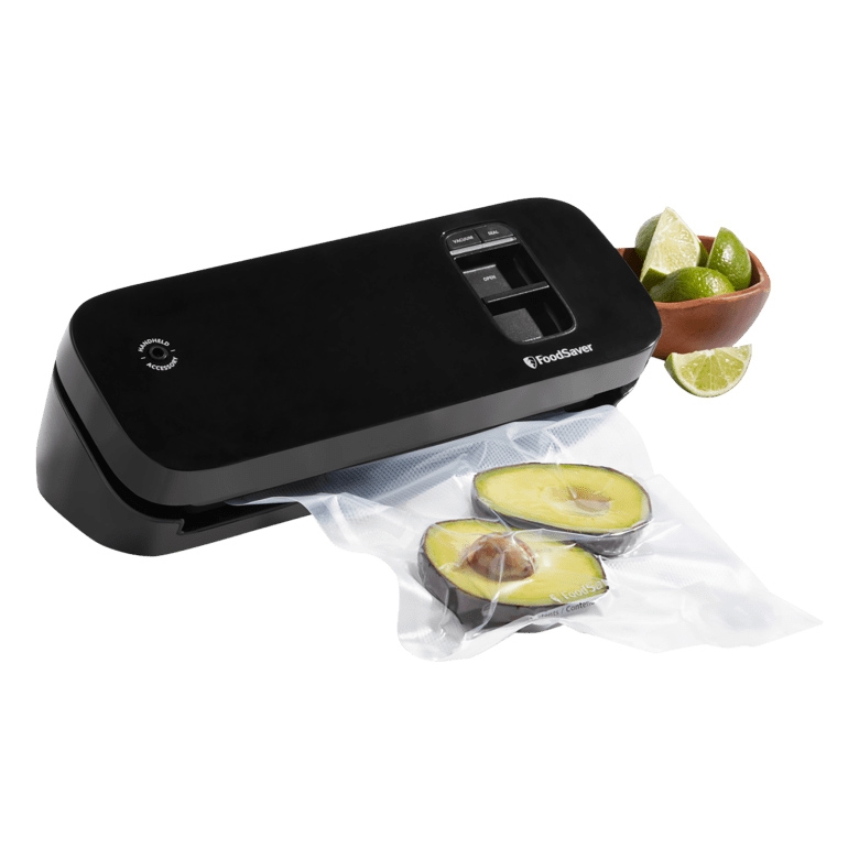 A FoodSaver vacuum sealer beside a sealed bag with avocado halves and a bowl with limes.