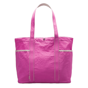 A vibrant pink lululemon Daily Multi-Pocket Tote Bag featuring dual shoulder straps, multiple compartments for organization, and a minimalist logo detail on the front.