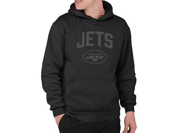 A person is wearing a black hoodie with \“JETS New York Jets\“ printed in dark lettering.