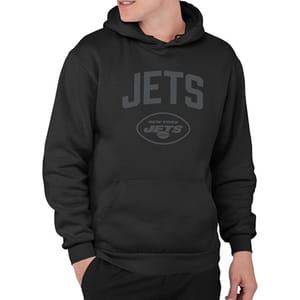 A person is wearing a black hoodie with \“JETS New York Jets\“ printed in dark lettering.