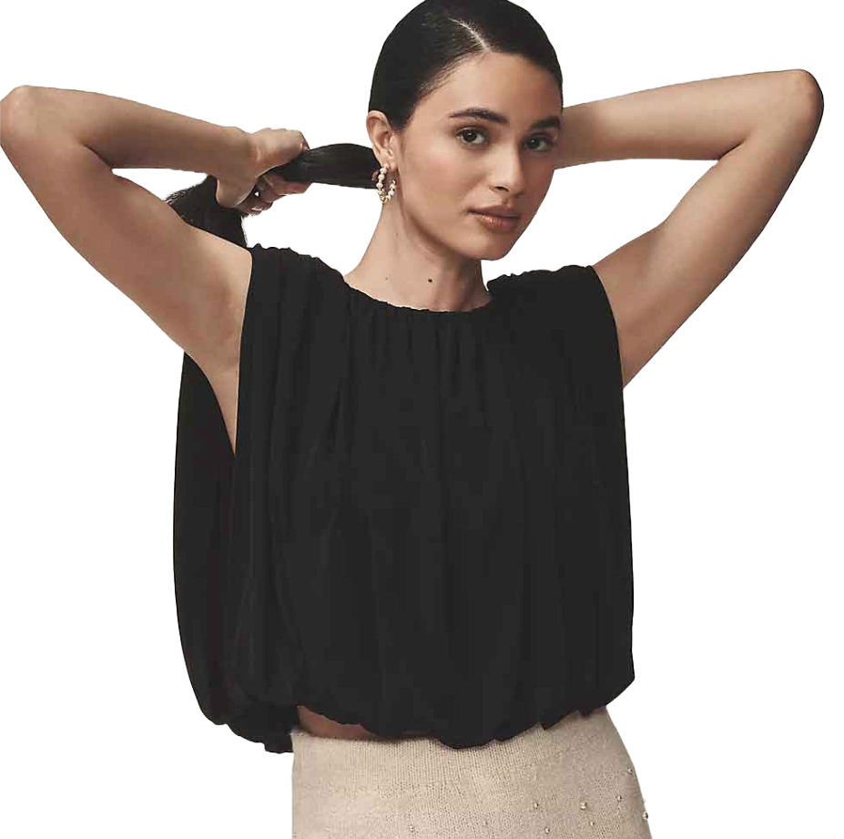The Dolan Left Coast Bubble Top is a sleeveless, loose-fitting top with a gathered neckline, featuring a voluminous silhouette in black, paired with a light-colored skirt.