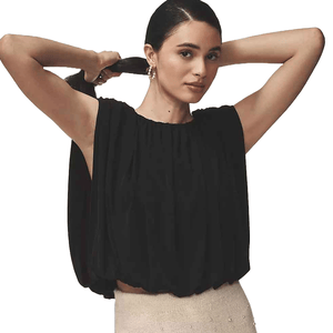 The Dolan Left Coast Bubble Top is a sleeveless, loose-fitting top with a gathered neckline, featuring a voluminous silhouette in black, paired with a light-colored skirt.