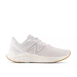 The New Balance Fresh Foam Arishi shoes are lightweight, featuring a white mesh upper with a supportive synthetic overlay, a cushioned Fresh Foam midsole, and a gum rubber outsole for traction. The design includes an \“N\“ logo on the side.