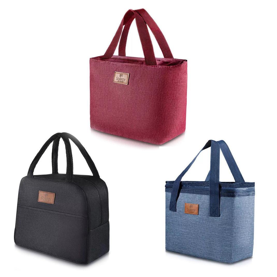 Three canvas lunch bags in different colors: maroon, black, and blue, each with a brand label and carrying handles.