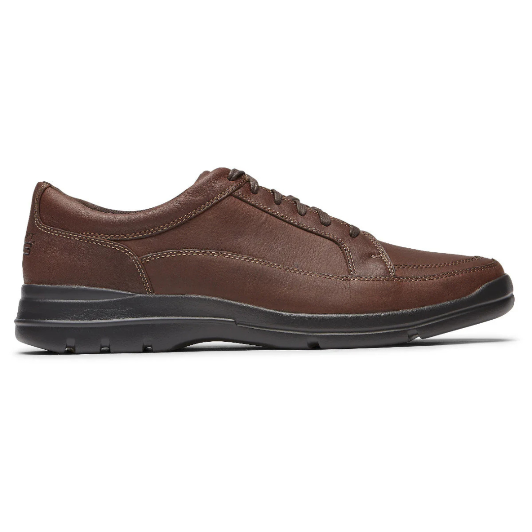 Brown leather casual shoe with black sole, featuring stitching detail and a lace-up design.