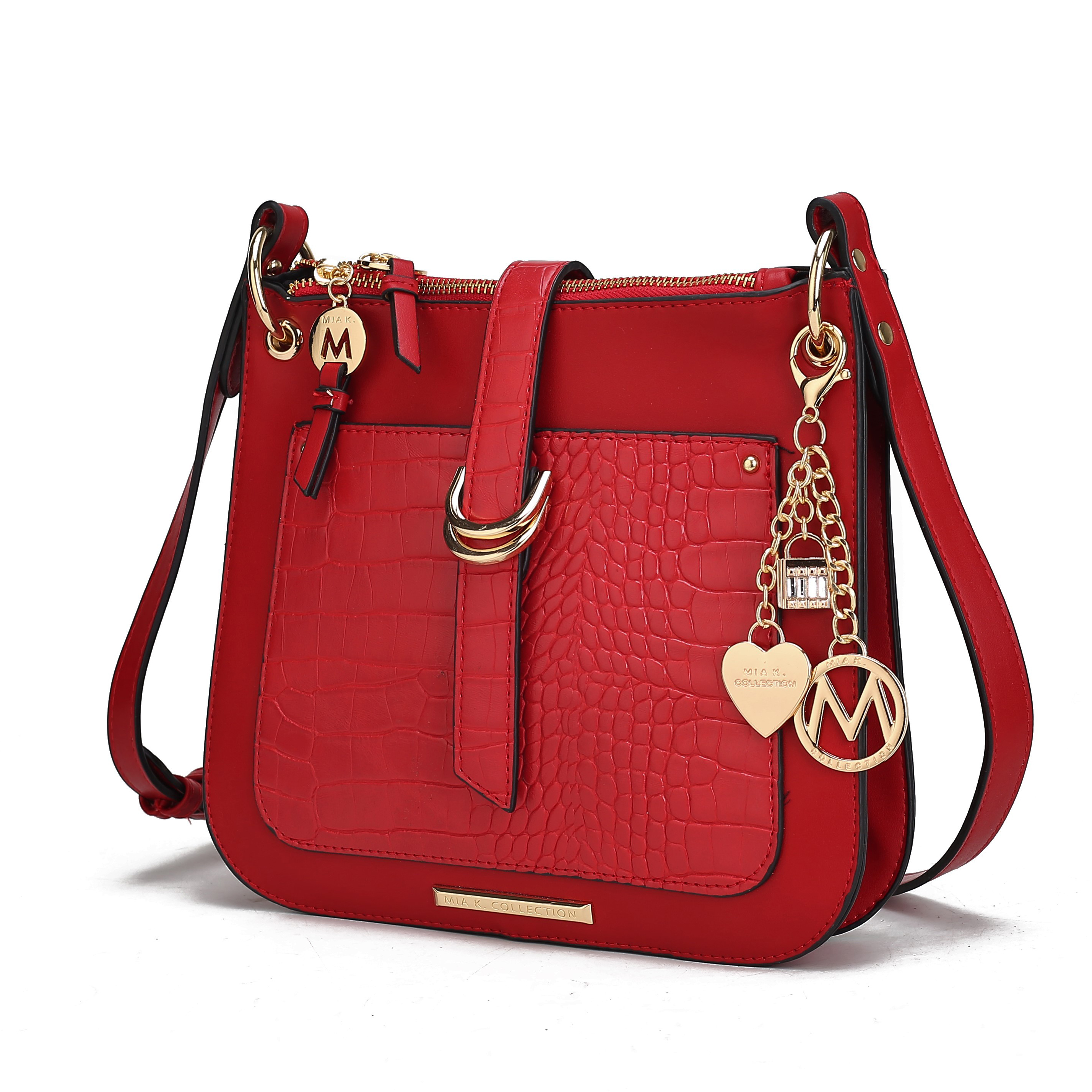 A red MKF embossed crossbody bag features a croc pattern and gold-tone hardware, charms, and buckle details. It has a front pocket and adjustable strap for convenience.
