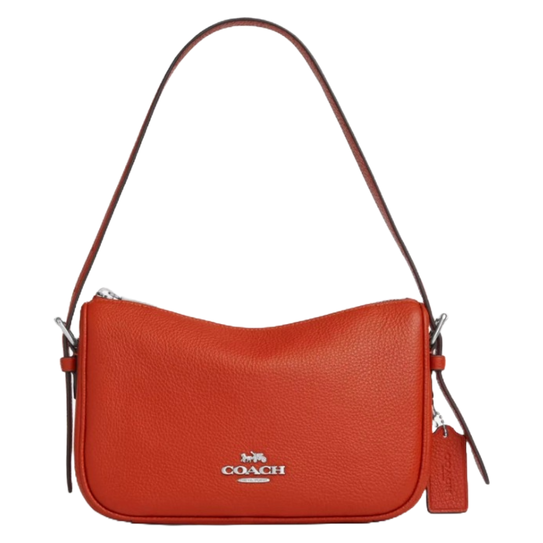 A red Coach shoulder bag with silver hardware, featuring the Coach logo and a matching leather tag.