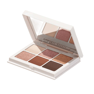 A makeup palette with six eyeshadow shades in a mix of matte and shimmer finishes housed in a white rectangular case with a mirror.