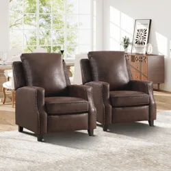 Two brown leather recliner chairs with nailhead trim and black legs are placed on a light-colored rug in a stylish living room setting.