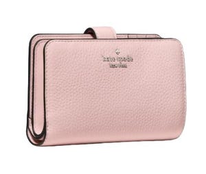 A pink leather wallet with a pebbled texture, featuring the \“kate spade new york\“ logo embossed on the front.