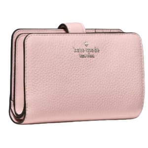 A pink leather wallet with a pebbled texture, featuring the \“kate spade new york\“ logo embossed on the front.