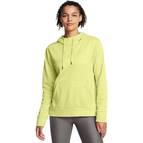 A woman is wearing a light green hoodie with a front pocket and drawstrings, paired with gray leggings.
