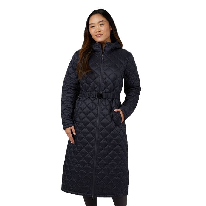 A woman is wearing a long black diamond-quilted coat with a high collar, zip closure, and a belt at the waist. The coat has side pockets and extends to mid-calf.