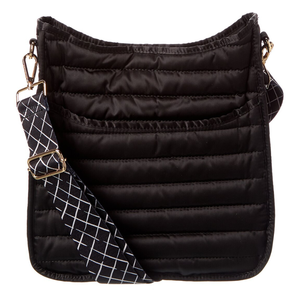 A black quilted crossbody bag with a wide, adjustable strap featuring a white geometric pattern.