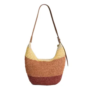 A multicolored woven shoulder bag with horizontal stripes in shades of brown, orange, and yellow, featuring a brown leather strap.