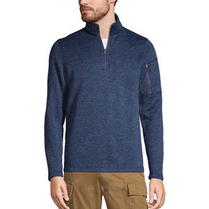 A man is wearing a navy blue quarter-zip pullover with long sleeves and a zippered pocket on the left arm, paired with khaki cargo pants.