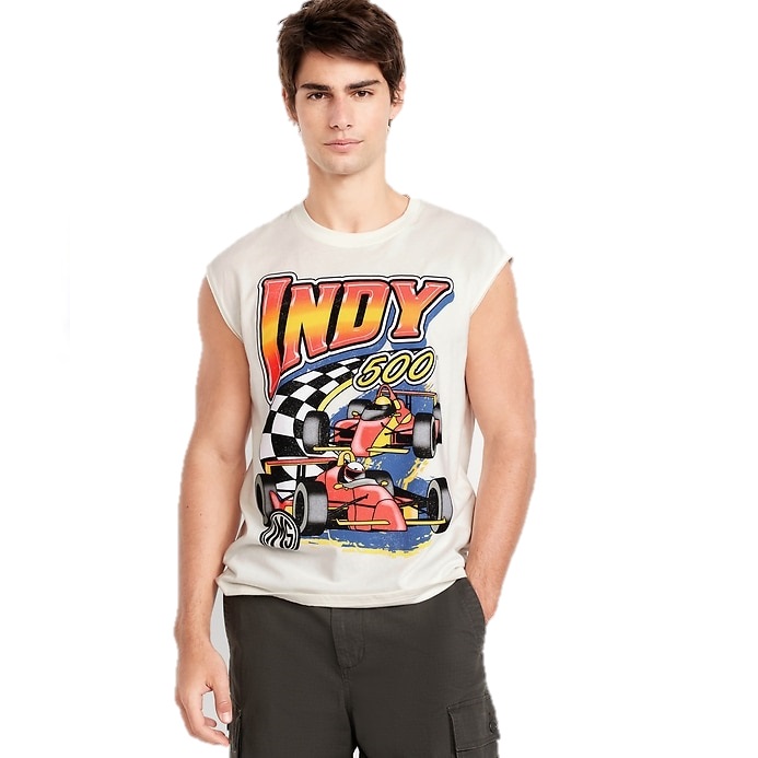 A man wears a sleeveless shirt with a colorful \“Indy 500\“ design featuring race cars and a checkered flag. He pairs it with dark cargo shorts.
