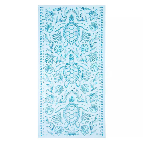 Blue and white beach towel featuring sea turtle and seashell patterns.
