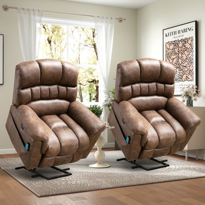 Two brown, leather-look recliner chairs are shown in a living room setting, positioned with a small round table between them. They have padded, tufted designs, with controls on the side, and are partially reclined.