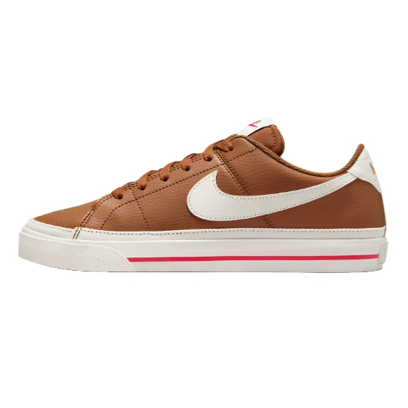 A brown low-top sneaker with a white sole, featuring a white swoosh logo and a thin red stripe detail on the sole.
