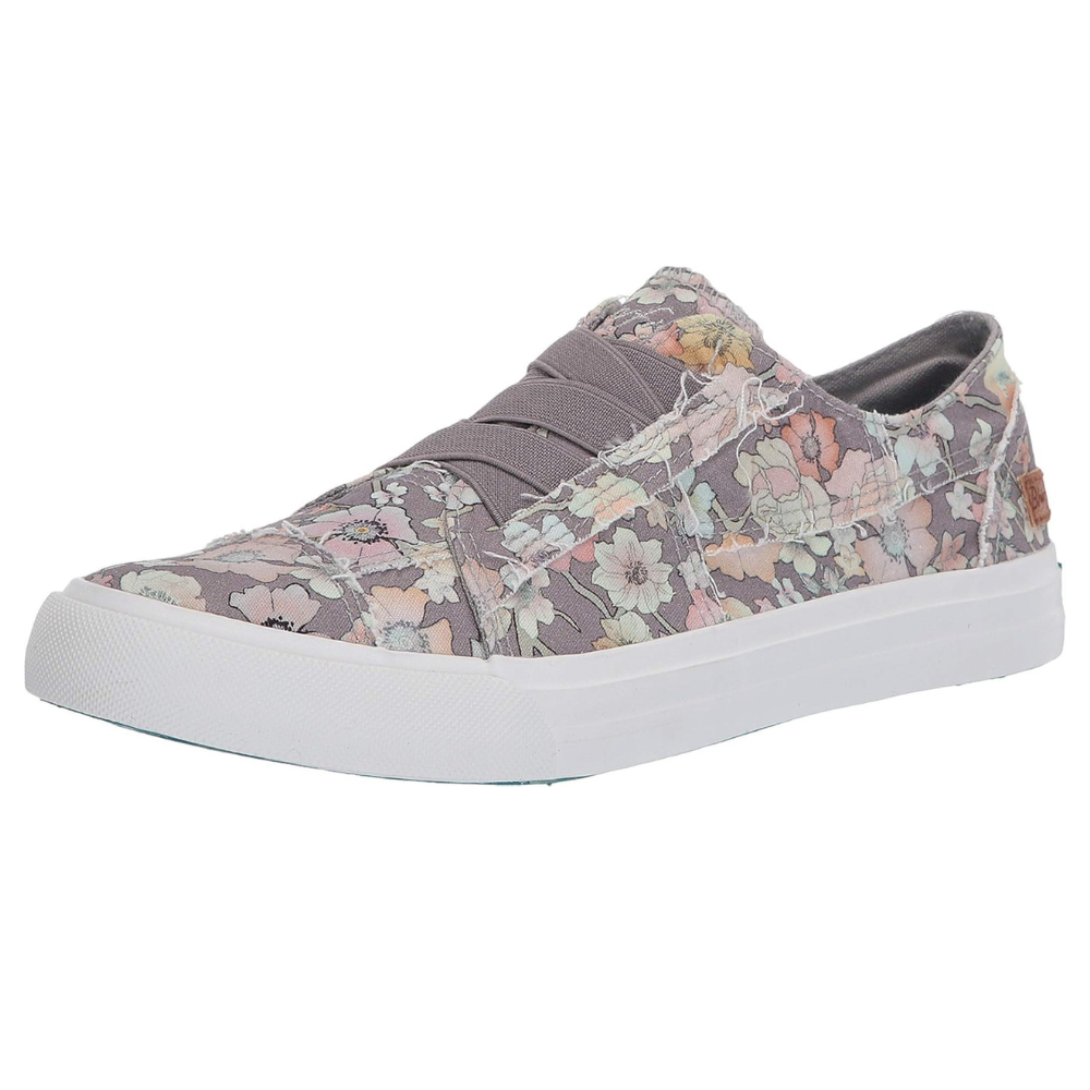 A floral-patterned slip-on sneaker with a white rubber sole and elastic bands across the top for easy wearing.