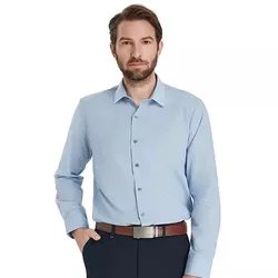 A man wears a light blue button-up shirt with long sleeves and a classic collar, paired with dark trousers and a brown belt.
