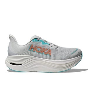 A light gray and turquoise Hoka running shoe with a thick, wavy sole and noticeable cushioning. The brand logo is prominently displayed on the side.