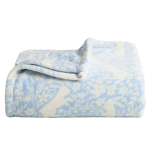 A folded blue and white fleece blanket with a floral and animal pattern.