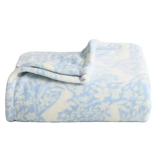 A folded blue and white fleece blanket with a floral and animal pattern.