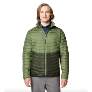 A man is wearing a light green Columbia insulated jacket with darker green accents, over a dark blue shirt.