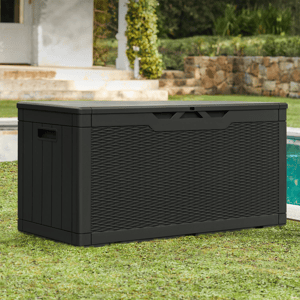 A black outdoor storage box with a wicker-style texture, situated near a pool in a garden setting.