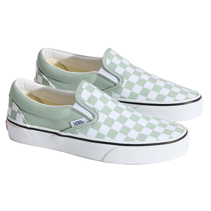 Vans slip-on shoes with a green and white checkerboard pattern, featuring a white rubber sole and black trim.