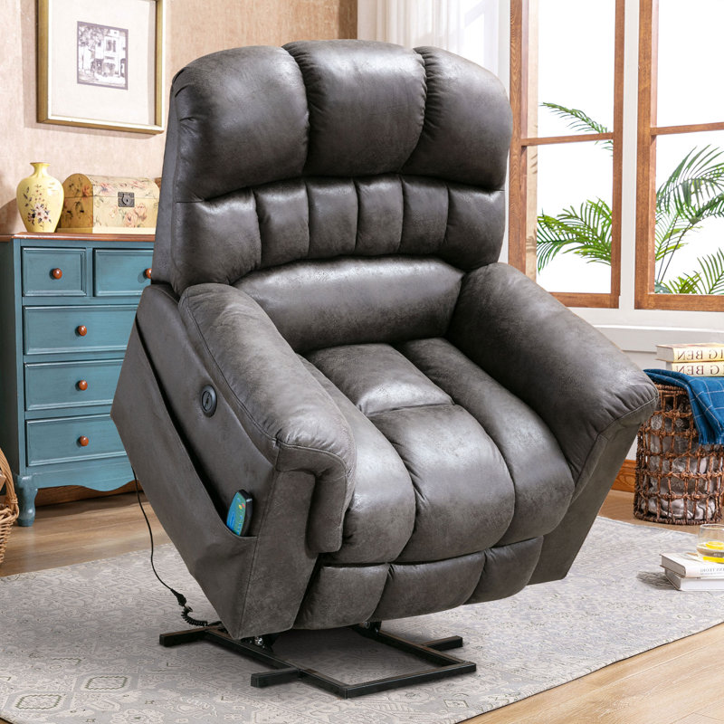A plush, padded recliner chair with an attached remote control, in a room with a blue chest of drawers and decorative items.