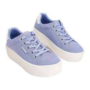 Light purple Skechers platform sneakers with lace-up closure, white rubber soles, and metal eyelets. The sneakers feature a fabric upper and padded collars for added comfort.