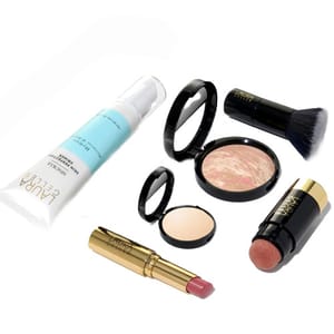 Laura Geller's 6-piece kit includes a foundation primer, marbled face powder, kabuki brush, compact setting powder, lipstick, and chubby blush stick, all designed for a complete makeup look.