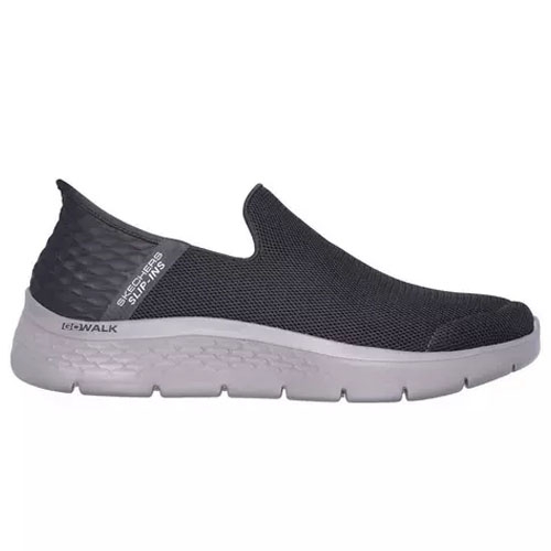 A black slip-on shoe with a white sole, featuring the \“Skechers Slip-ins\“ label on the heel.