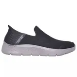 A black slip-on shoe with a white sole, featuring the \“Skechers Slip-ins\“ label on the heel.