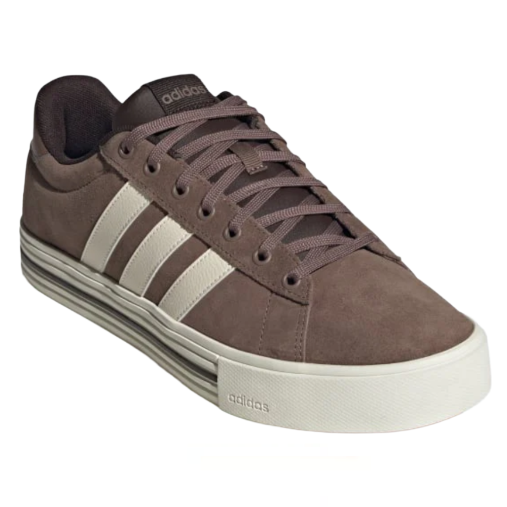 A brown Adidas sneaker with white stripes, featuring a low-top design, lace-up closure, and a thick white sole with stripe detailing.