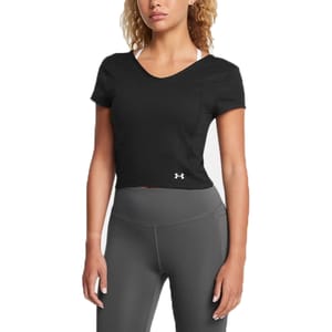 A woman is wearing a black Under Armour short-sleeve crop top and gray high-waisted leggings.