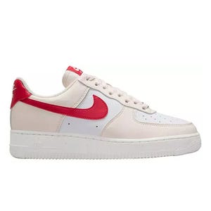A pair of white and red Nike Air Force 1 sneakers with a red swoosh and white sole.