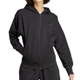 A person is wearing a black zip-up hoodie with a hood and elastic cuffs, featuring a subtle logo on the chest. They are also wearing matching black sweatpants.