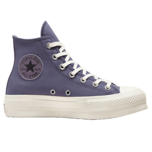 Converse All Star Lift Platform Shoes in a high-top style feature a canvas upper in purple with white laces and eyelets, a rubber toe cap, and a thick white platform sole, showcasing the iconic \“Converse All Star\“ logo on the side.
