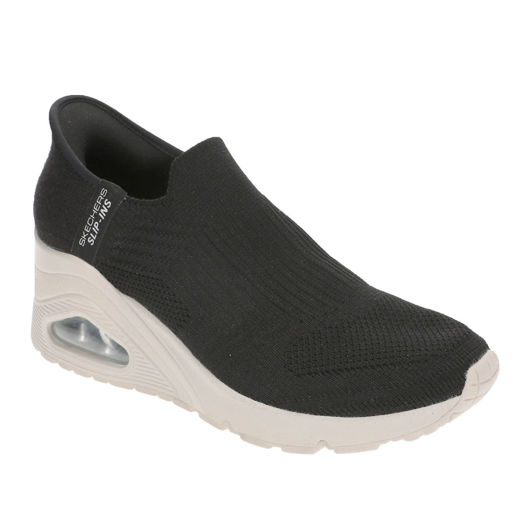 A black slip-on Skechers shoe with a knit upper, featuring a cushioned white midsole with an air pocket detail.